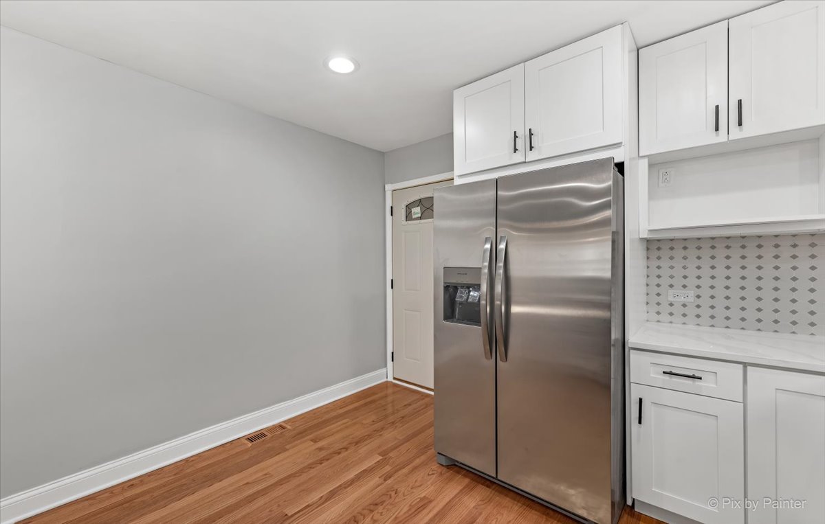 1902 South 9th Avenue Maywood, IL 60153 - Photo 4 of 51 a kitchen with cabinets and stainless steel appliances