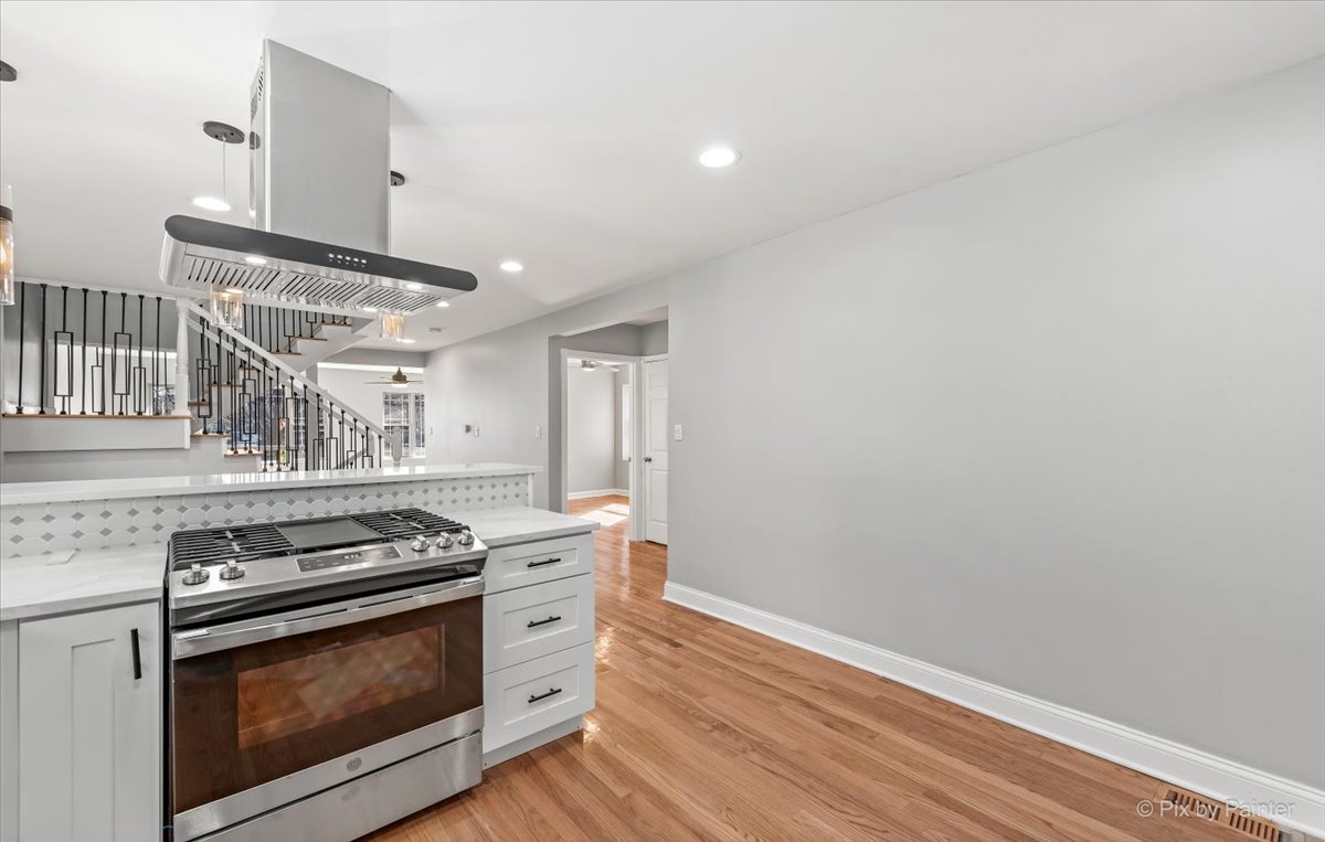 1902 South 9th Avenue Maywood, IL 60153 - Photo 6 of 51 a kitchen with granite countertop a stove and a wooden floor