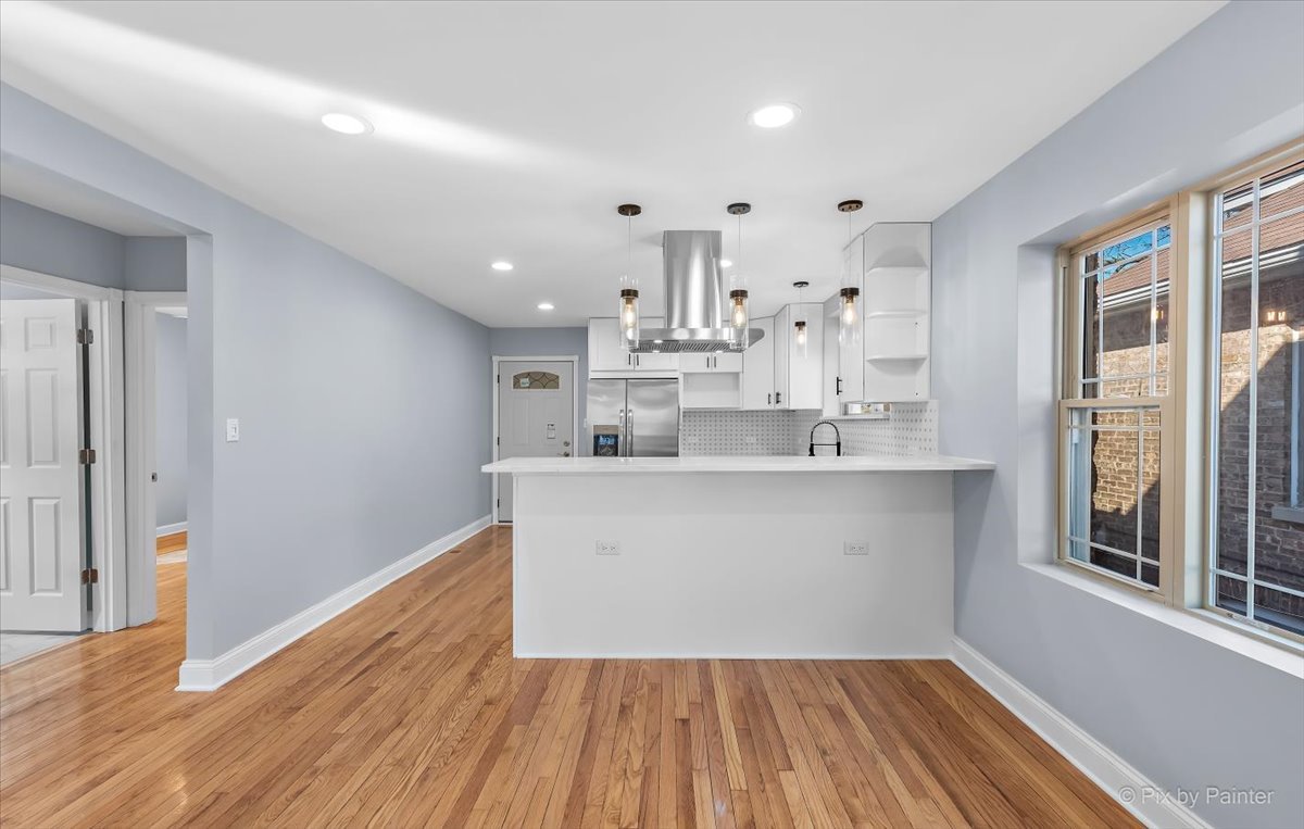 1902 South 9th Avenue Maywood, IL 60153 - Photo 9 of 51 a large white kitchen with wooden floor and a sink