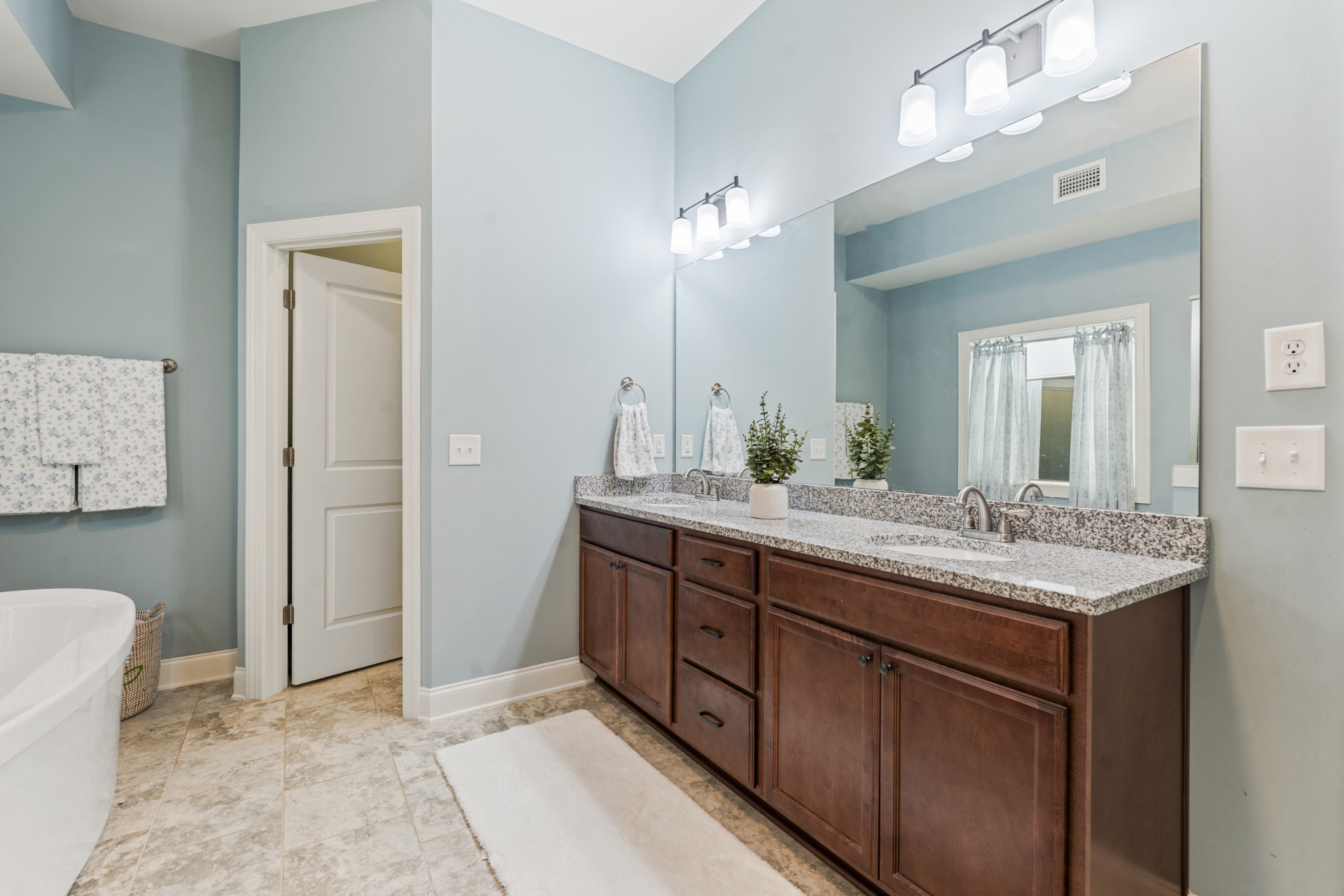 3433 Cortona Way Murfreesboro, TN 37129 - Photo 16 of 32 a bathroom with a granite countertop sink a toilet and a mirror