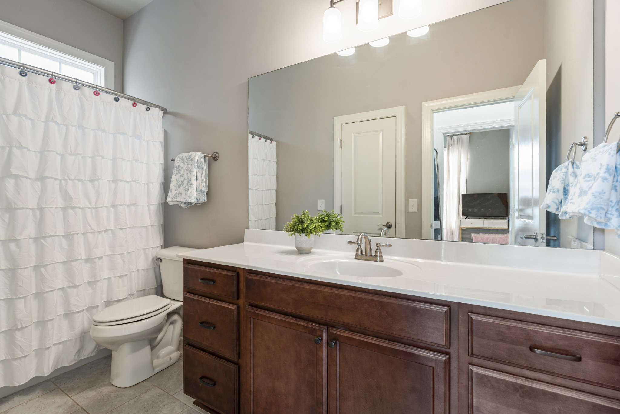 3433 Cortona Way Murfreesboro, TN 37129 - Photo 19 of 32 a bathroom with a double vanity sink toilet and a mirror