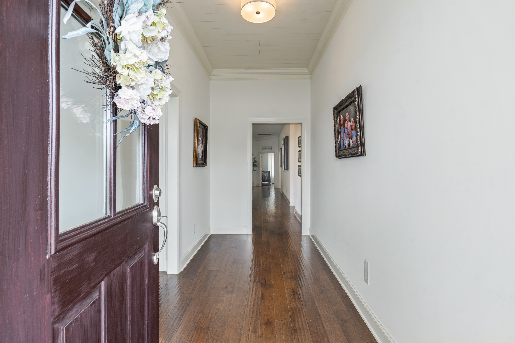 3433 Cortona Way Murfreesboro, TN 37129 - Photo 8 of 32 a view of a hallway with wooden floor and a chandelier