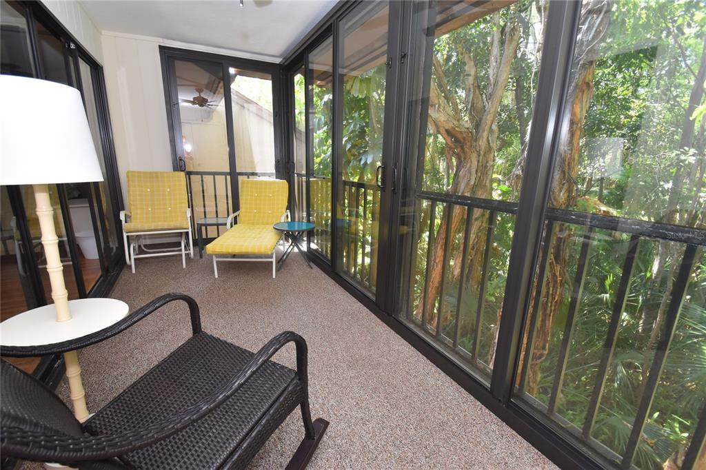 1677 Brookhouse Circle, Unit BR224 Sarasota, FL 34231 - Photo 11 of 12 a balcony with chairs and a table