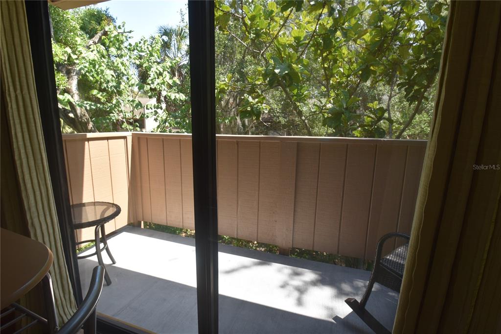 1677 Brookhouse Circle, Unit BR224 Sarasota, FL 34231 - Photo 12 of 12 a view of a porch with a yard