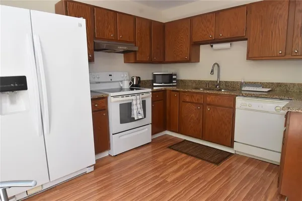 a kitchen with a refrigerator sink and cabinets