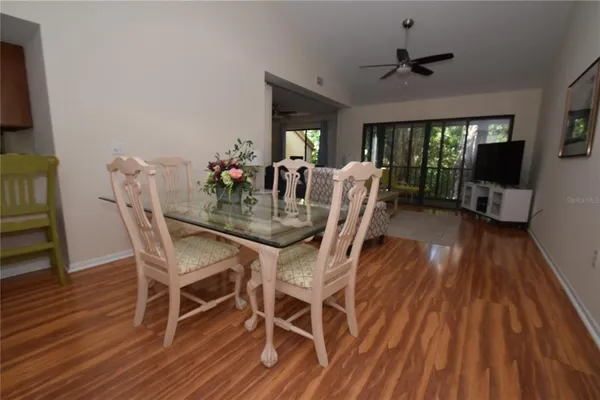 a view of a dining room with furniture window and wooden floor