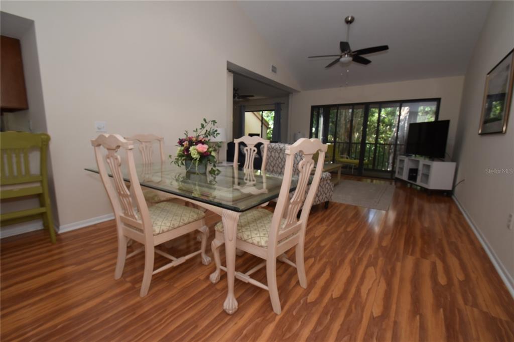 1677 Brookhouse Circle, Unit BR224 Sarasota, FL 34231 - Photo 3 of 12 a view of a dining room with furniture window and wooden floor