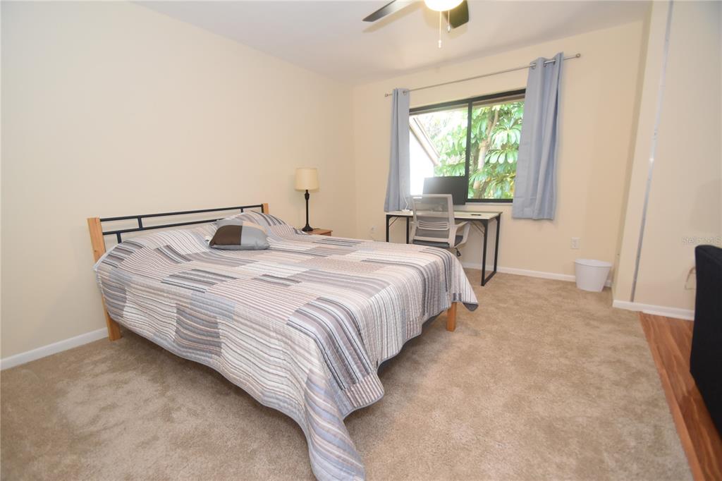 1677 Brookhouse Circle, Unit BR224 Sarasota, FL 34231 - Photo 6 of 12 a bedroom with a bed and a window