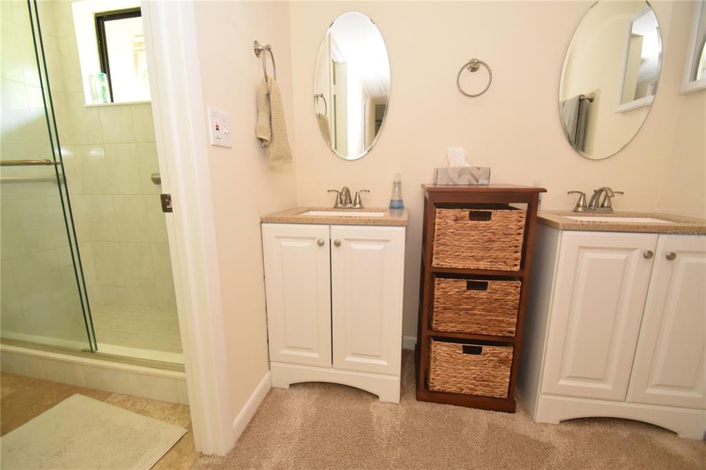 1677 Brookhouse Circle, Unit BR224 Sarasota, FL 34231 - Photo 8 of 12 a bathroom with a sink a mirror and a shower
