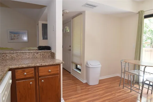 a spacious bathroom with a granite countertop sink toilet a large mirror and shower