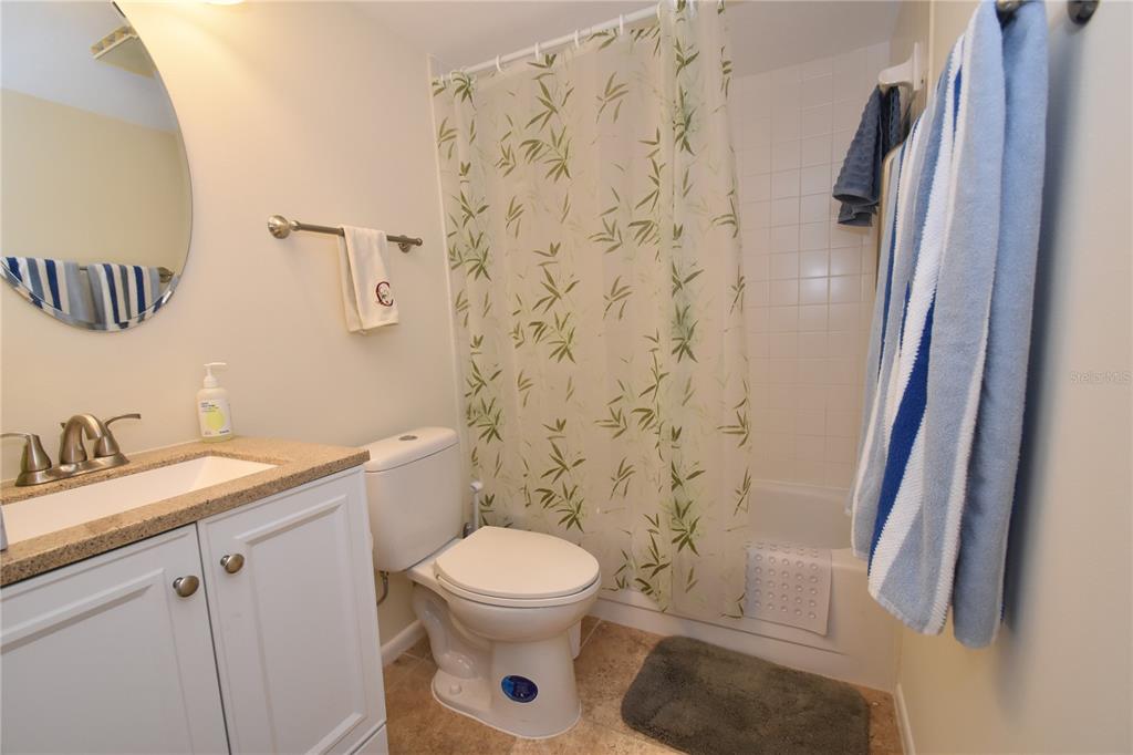 1677 Brookhouse Circle, Unit BR224 Sarasota, FL 34231 - Photo 10 of 12 a white toilet sitting next to a bathroom sink