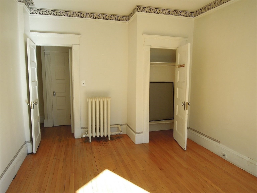 8 Garrison Street, Unit 209 Boston, MA 02116 - Photo 20 of 33 a view of empty room with wooden floor