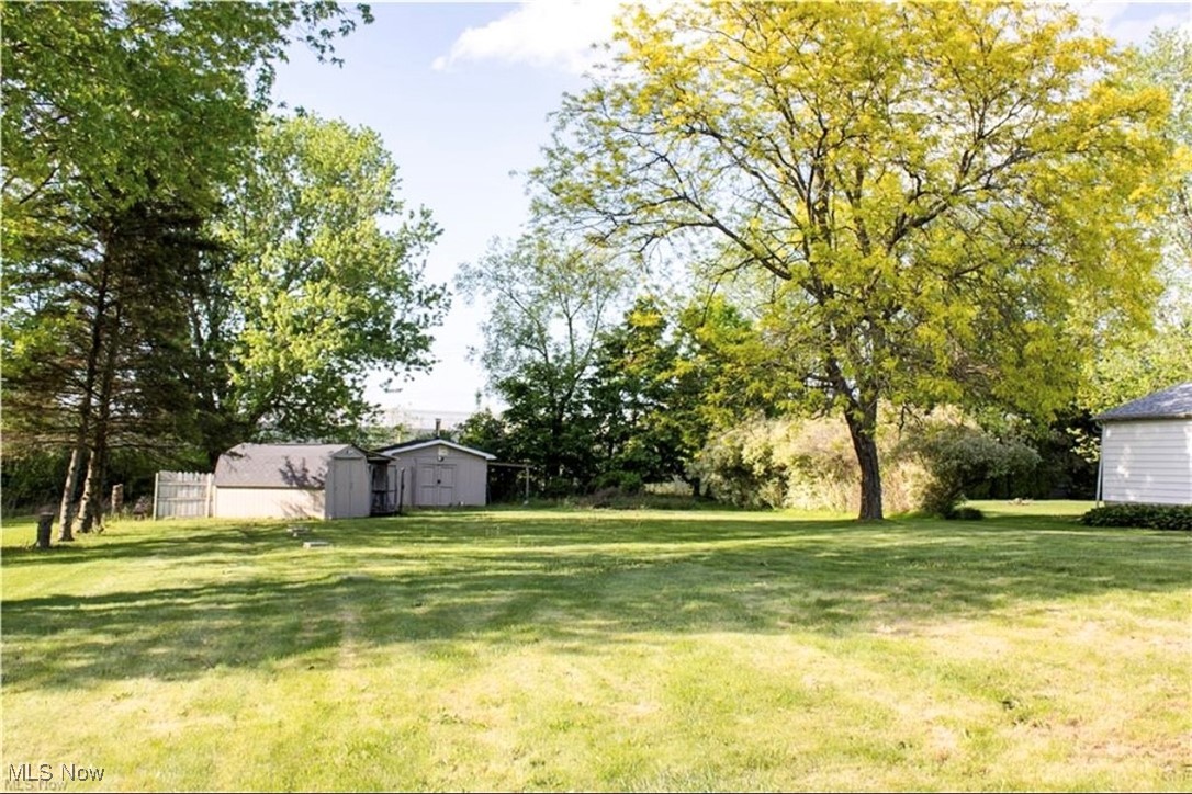 6333 Warren - Sharon Road Brookfield, OH 44403 - Photo 18 of 22 View of green lawn with an outdoor structure and view of wooded area
