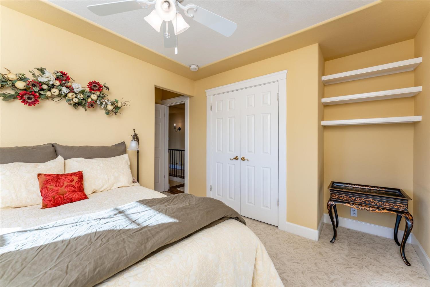 28853 Limestone Way Coarsegold, CA 93614 - Photo 32 of 54 a bedroom with a bed and a chandelier