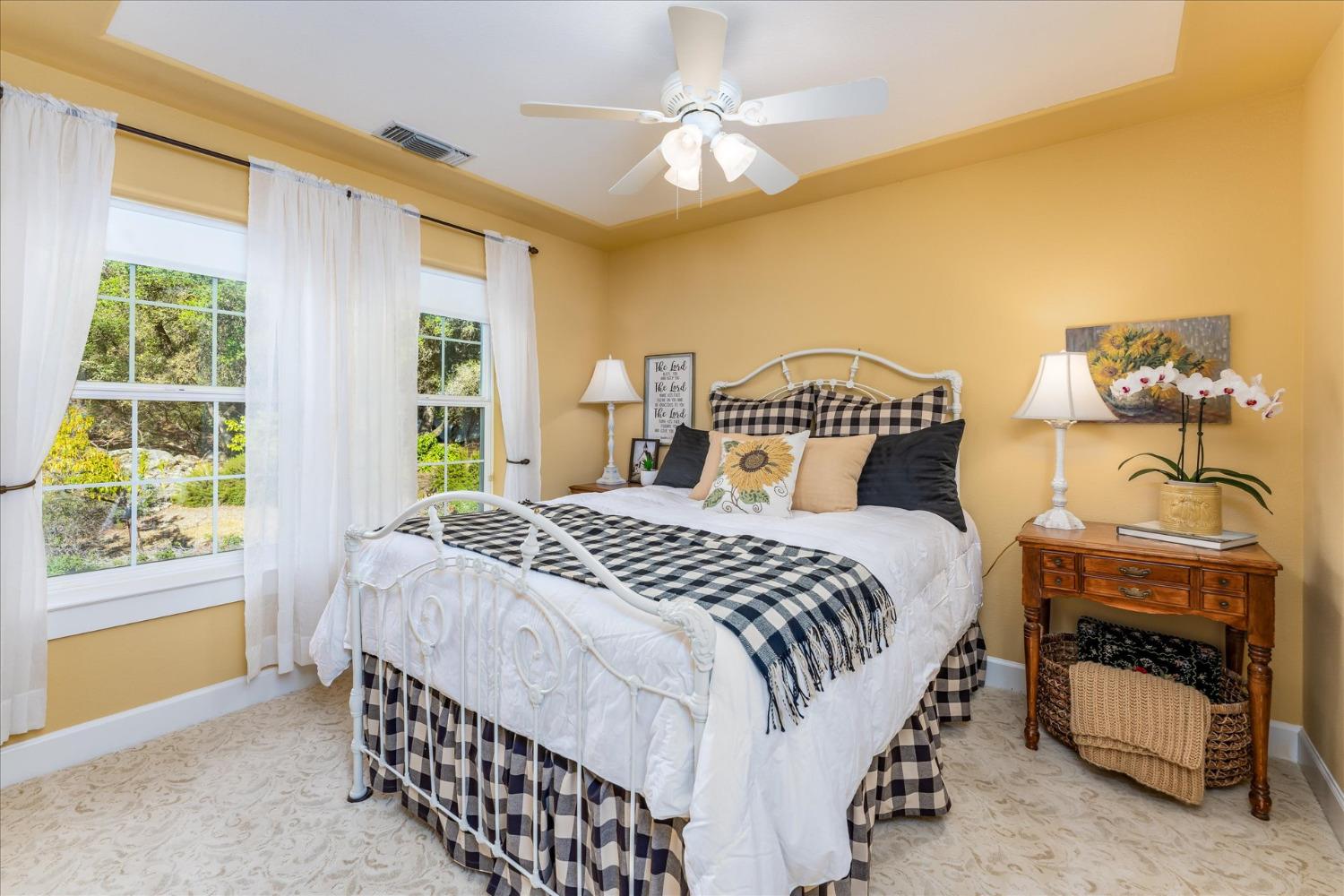 28853 Limestone Way Coarsegold, CA 93614 - Photo 33 of 54 a bedroom with a bed and a chandelier