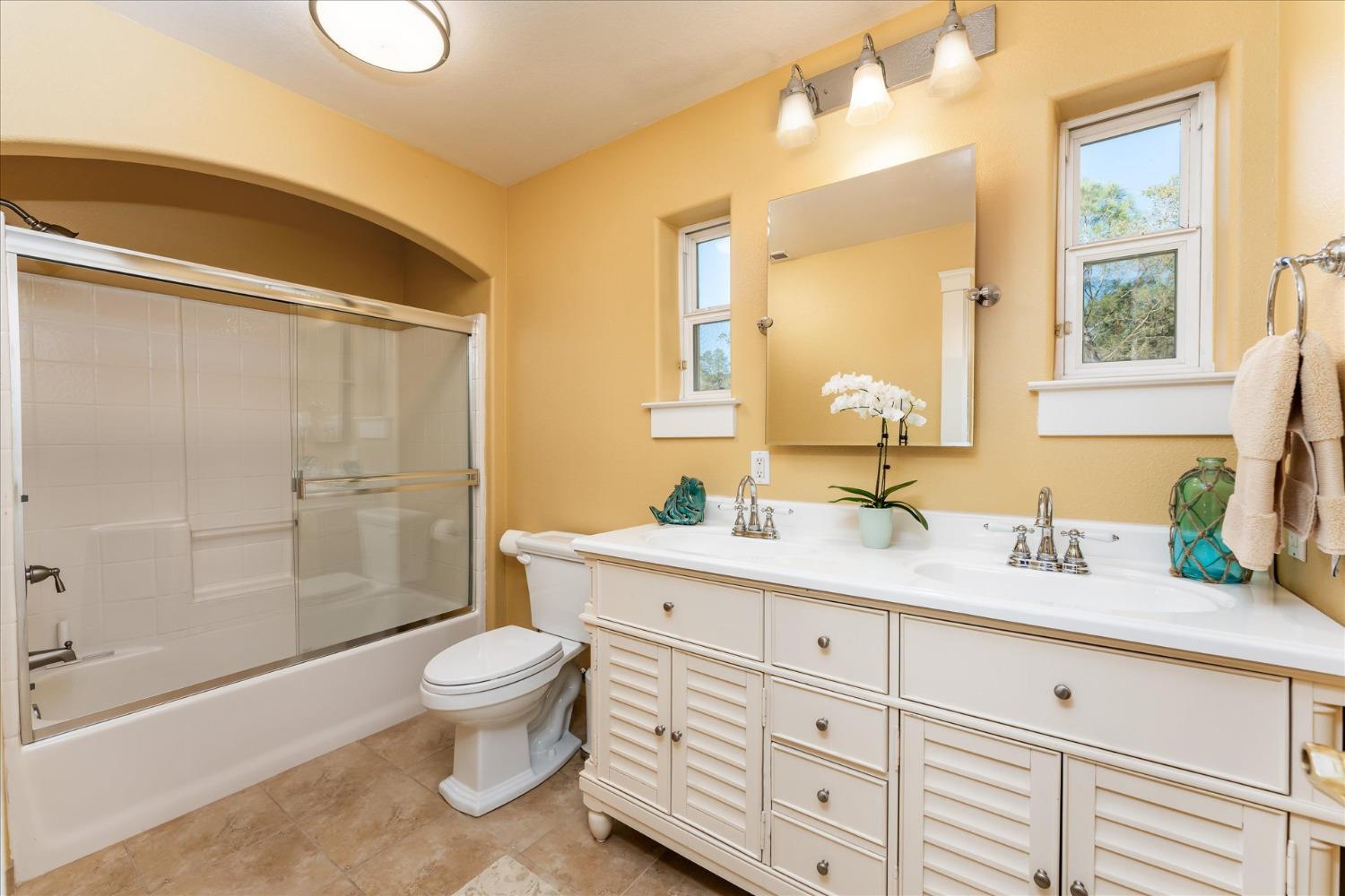 28853 Limestone Way Coarsegold, CA 93614 - Photo 35 of 54 a spacious bathroom with a granite countertop sink toilet and shower