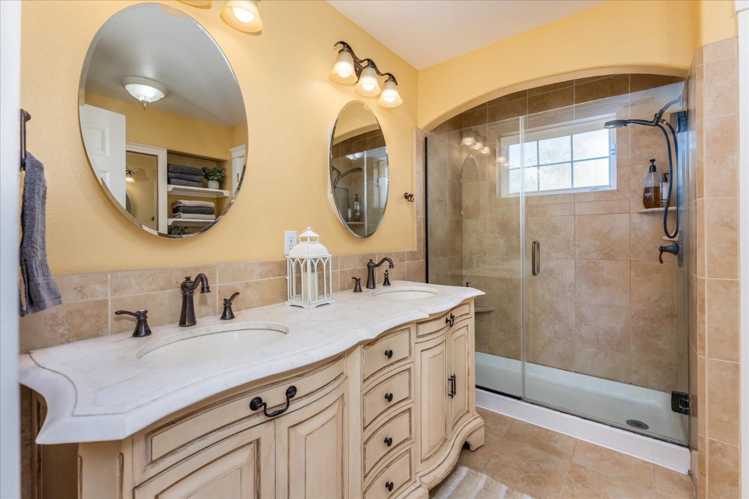 28853 Limestone Way Coarsegold, CA 93614 - Photo 40 of 54 a bathroom with a double vanity sink mirror and shower
