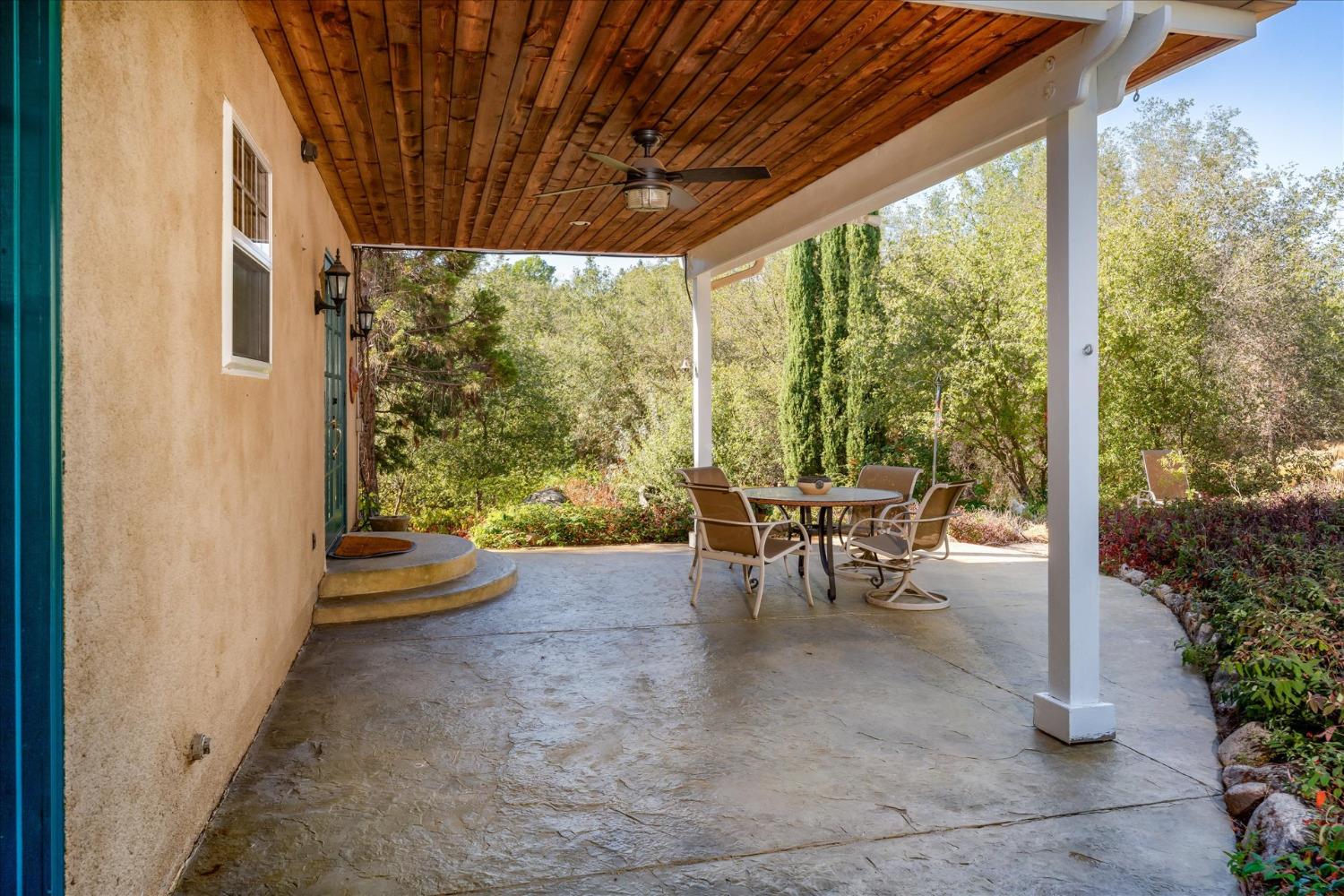 28853 Limestone Way Coarsegold, CA 93614 - Photo 44 of 54 a view of a patio with chairs and floor to ceiling window