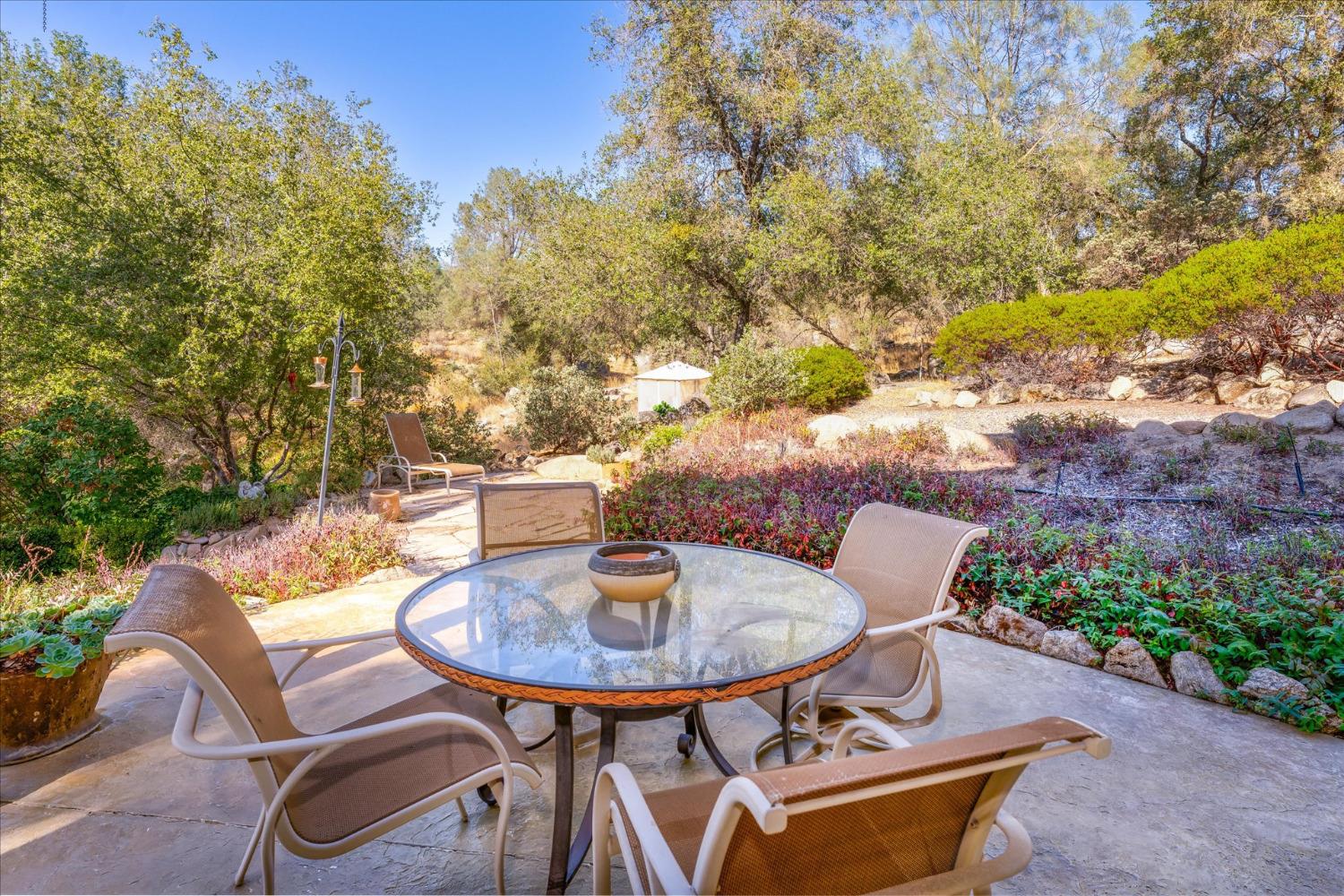 28853 Limestone Way Coarsegold, CA 93614 - Photo 45 of 54 a backyard of a house with table and chairs