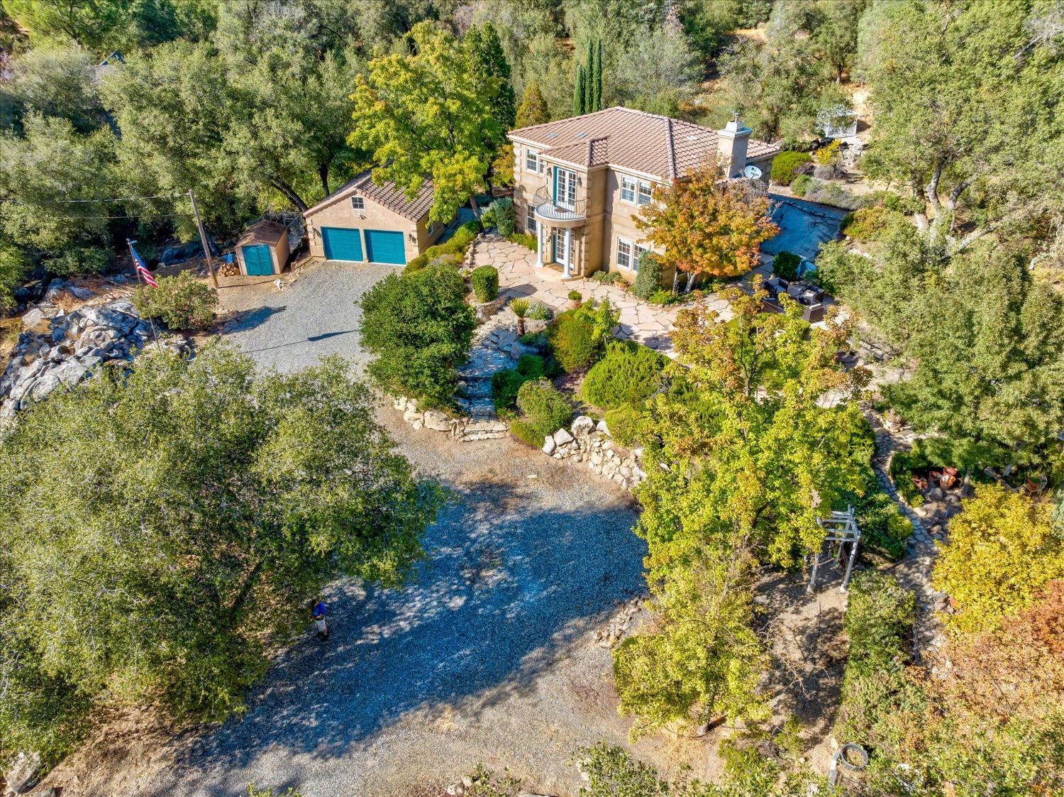 28853 Limestone Way Coarsegold, CA 93614 - Photo 8 of 54 a view of a house with a yard and large trees