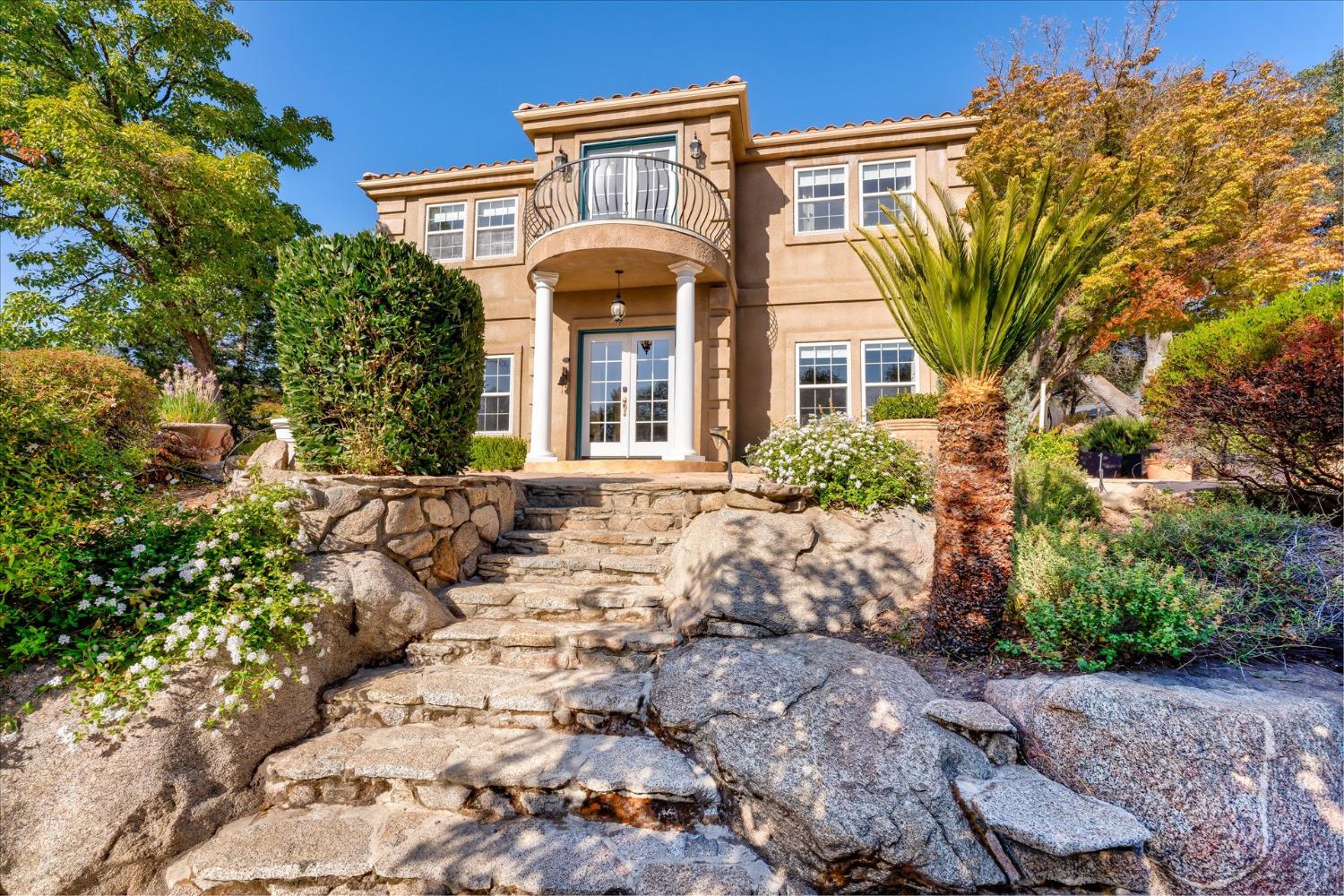 28853 Limestone Way Coarsegold, CA 93614 - Photo 10 of 54 a front view of a house with a garden