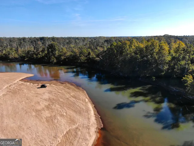 an aerial view of house with yard and mountain view in back