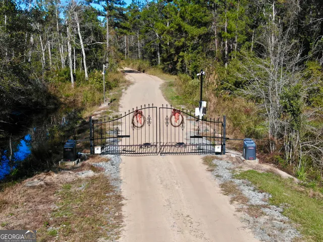 a view of house with a yard and sitting area