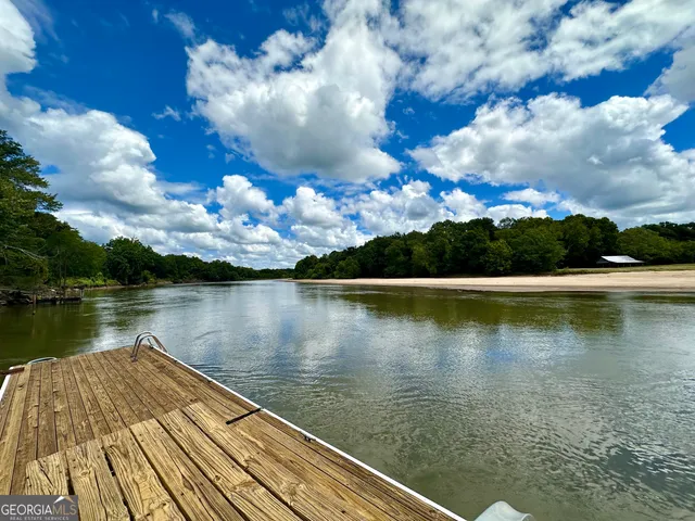 a spacious bedroom with a bed and a flat screen tv