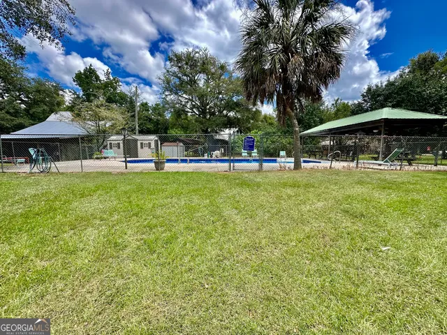 a bathroom with a sink a toilet a mirror and shower