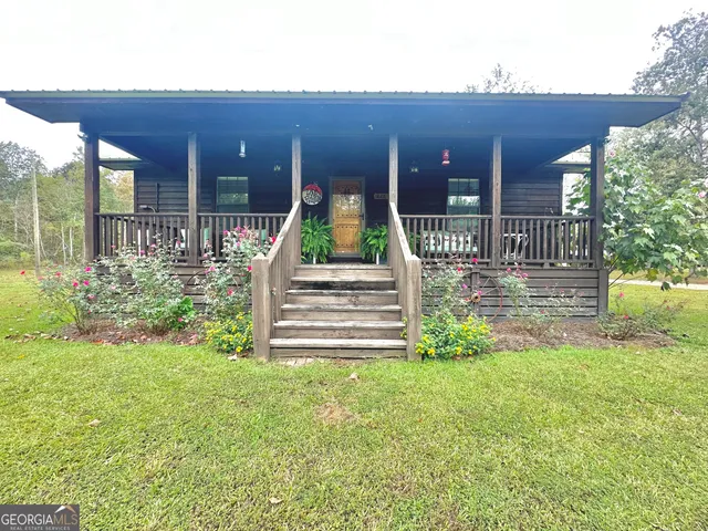 a view of a house with a yard and sitting area