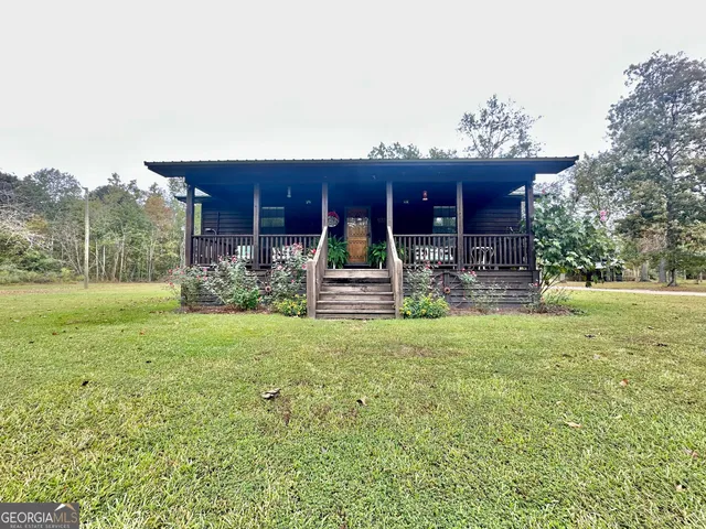 a view of a wooden house with a yard