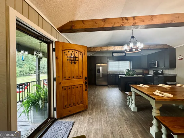 a view of a forest with trees in the background