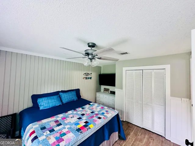 a view of a yard with plants and trees