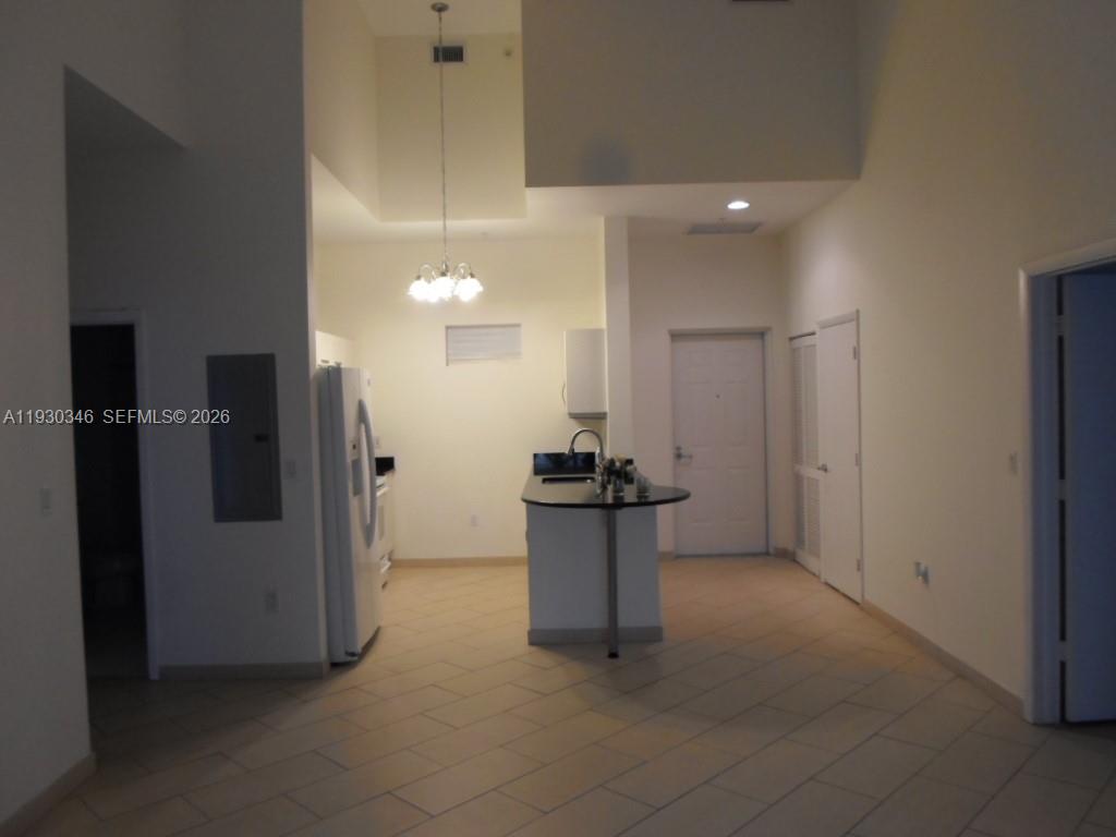 7275 Southwest 90th Way, Unit G 611 Miami, FL 33156 - Photo 41 of 56 a kitchen with stainless steel appliances kitchen island a refrigerator and a sink