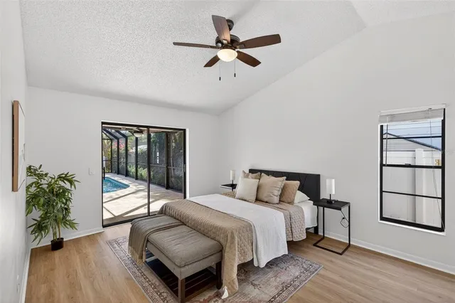 a bedroom with a bed and a large window