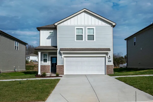 a front view of a house with a yard and garage