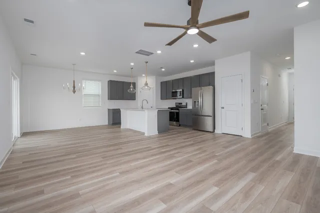 a view of a kitchen with a sink and a refrigerator