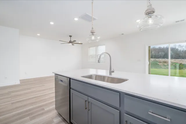 a kitchen with a sink and chandelier