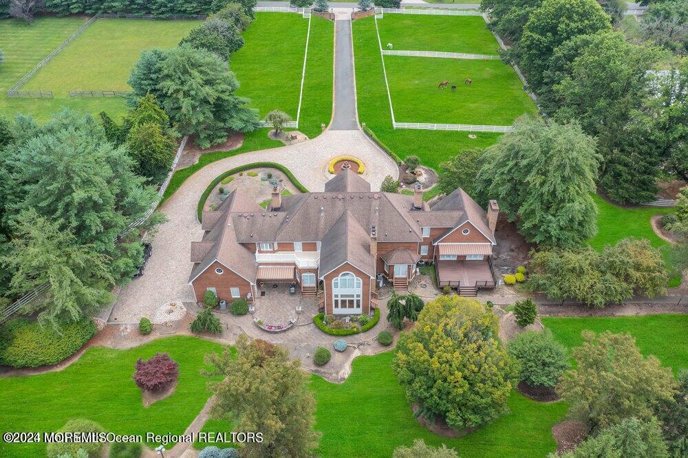 a aerial view of a house with garden space and trees all around
