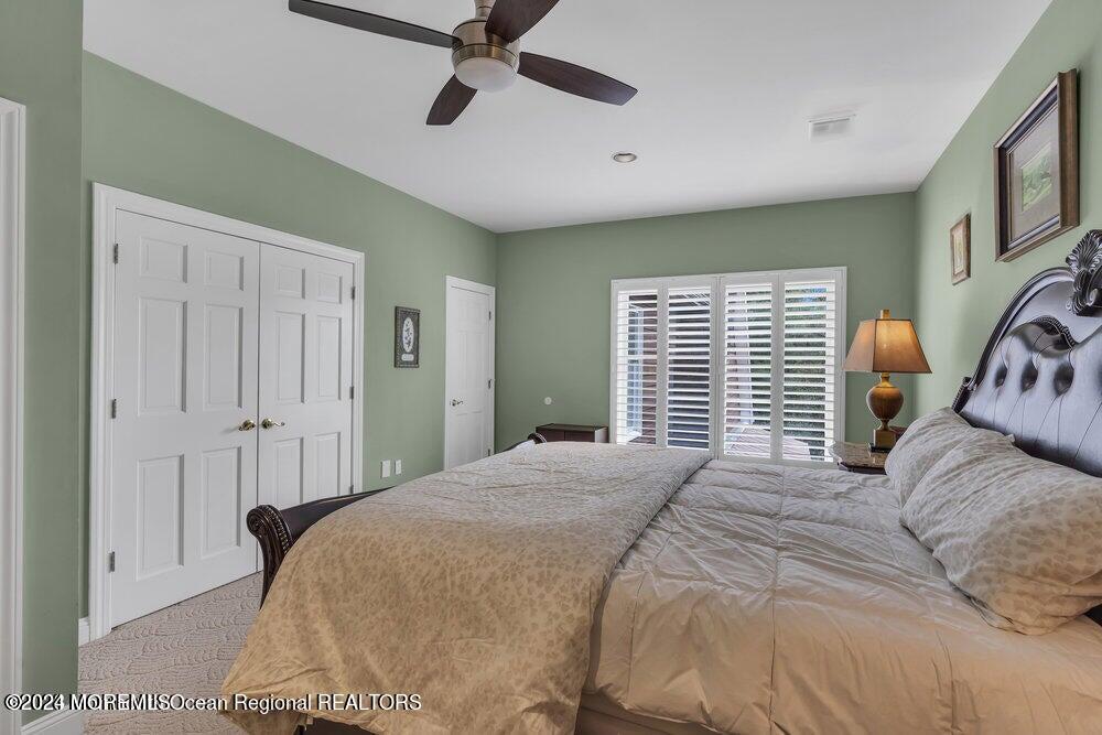 65 Cross Road Colts Neck, NJ 07722 - Photo 11 of 21 a bedroom with a bed and a chandelier