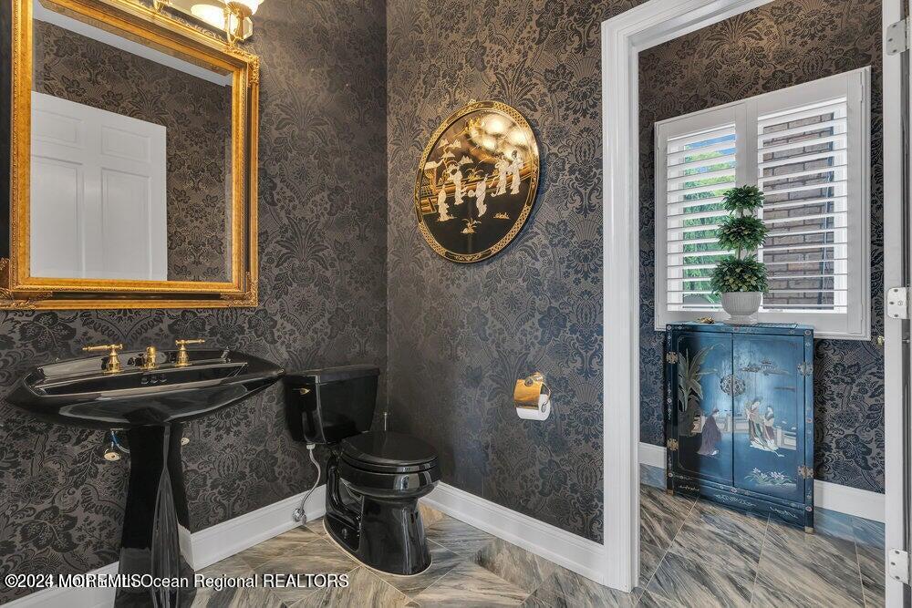 65 Cross Road Colts Neck, NJ 07722 - Photo 15 of 21 a bathroom with a sink a toilet and a mirror