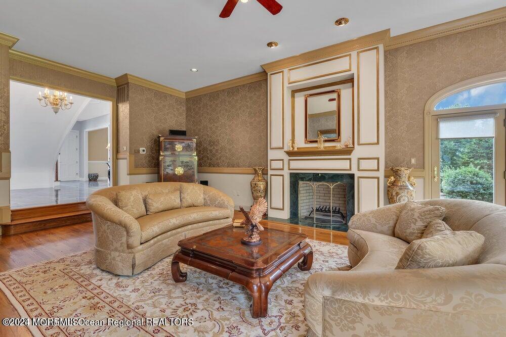 65 Cross Road Colts Neck, NJ 07722 - Photo 6 of 21 a living room with furniture a large window and a fireplace
