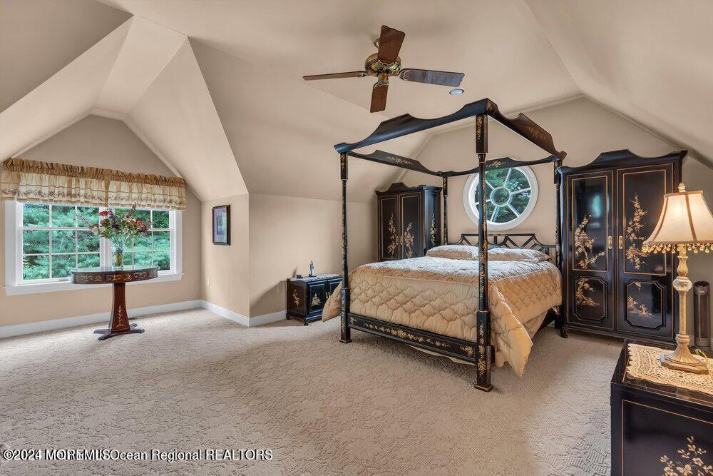 65 Cross Road Colts Neck, NJ 07722 - Photo 10 of 21 a bedroom with a bed a chandelier and a window