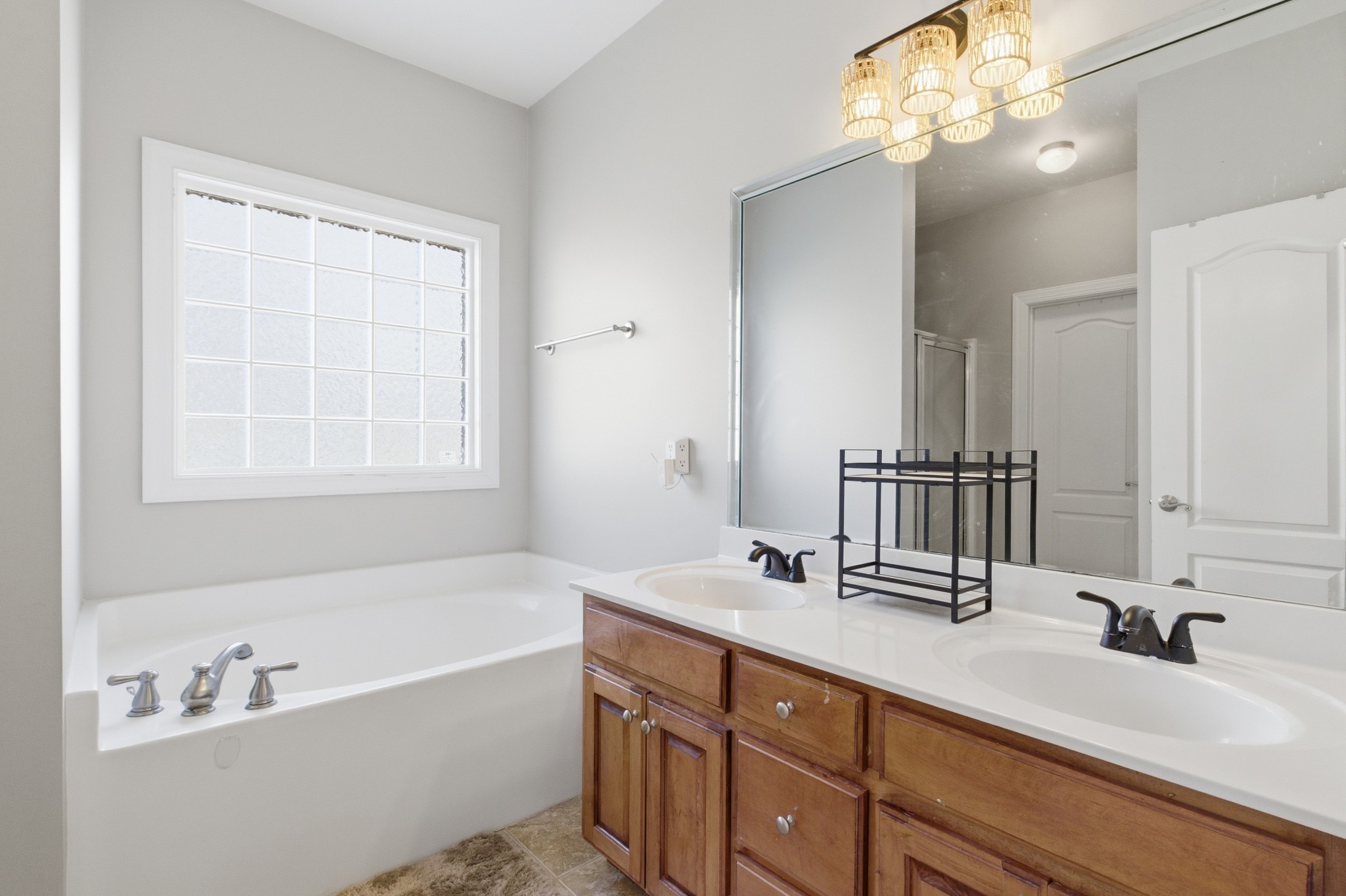 608 Windtree Pass Mount Juliet, TN 37122 - Photo 17 of 35 a bathroom with a tub a double vanity sink and a mirror
