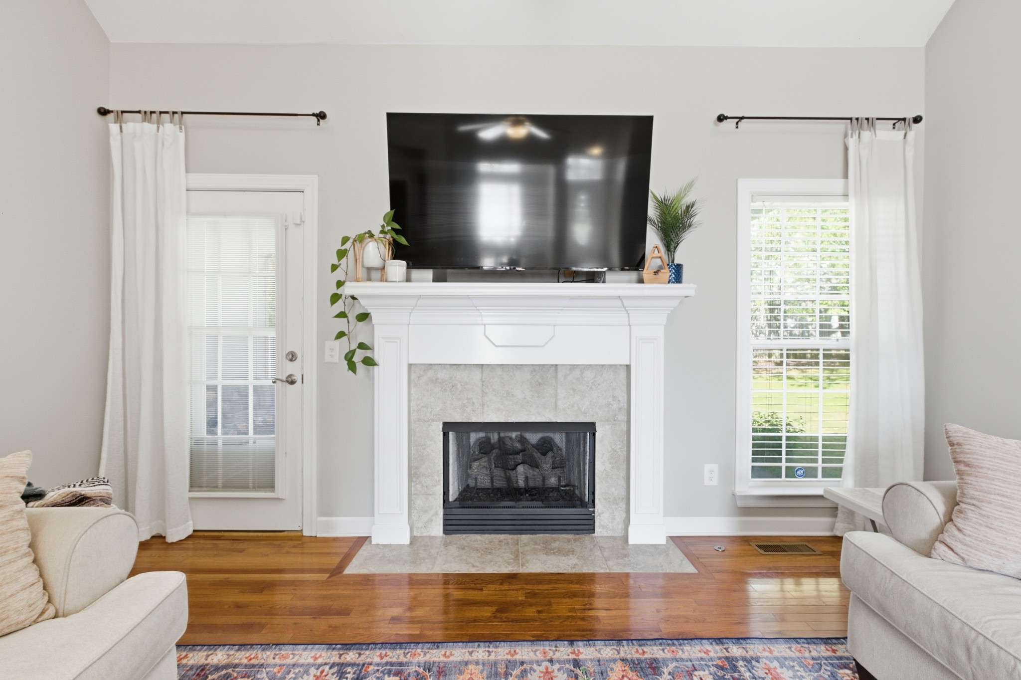 608 Windtree Pass Mount Juliet, TN 37122 - Photo 5 of 35 a living room with a fireplace and a flat screen tv