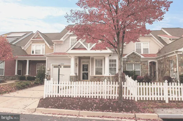 a front view of a house with a fence