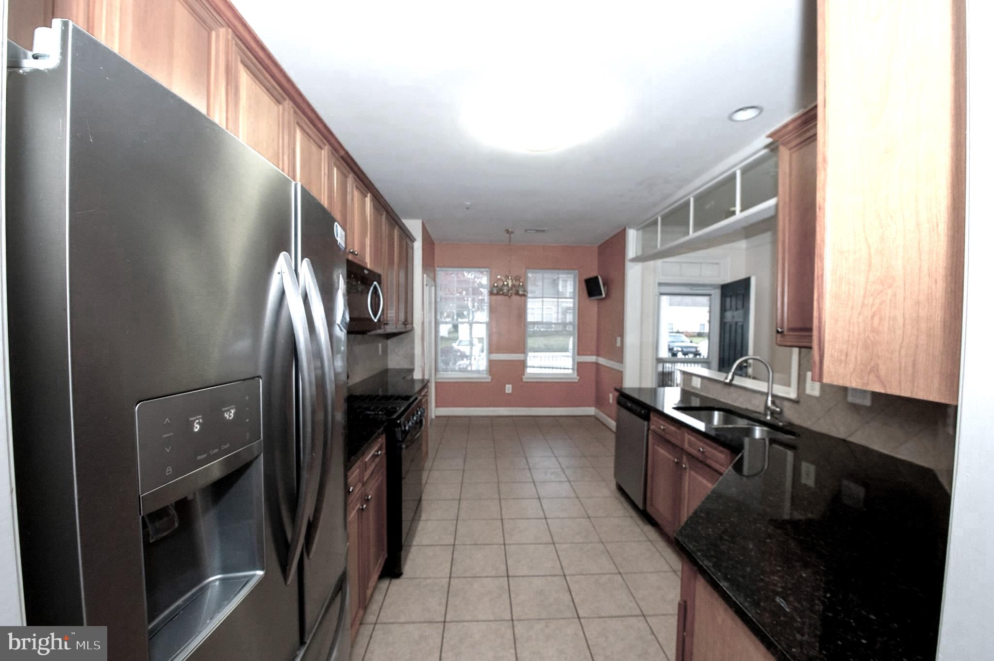 13204 Rabbit Chase Road Laurel, MD 20707 - Photo 2 of 35 a hallway with granite countertop a stove and a sink
