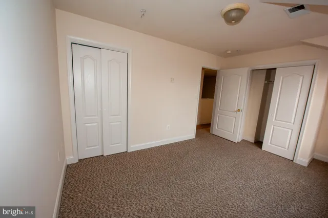 an empty room with closet and closet