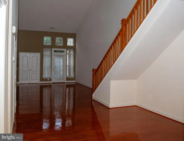 a view of entryway with wooden floor and stairs