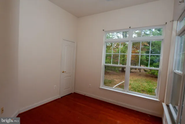 a view of an empty room with a floor to ceiling window and floor to ceiling window
